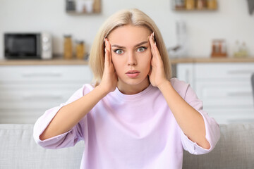 Stressed young woman at home