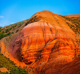 Big Bogdo mountain. Red sandstone outcrops on the slopes sacred mountain in Caspian steppe Bogdo -...