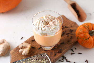 Glass of tasty pumpkin smoothie on table
