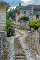 Fototapeta na wymiar Traditional architecture with narrow street and stone buildings a in Vitsa village central Zagori Greece