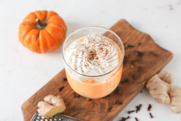 Glass of tasty pumpkin smoothie on table