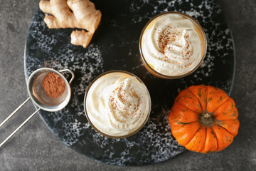 Glasses of tasty pumpkin smoothie on dark background
