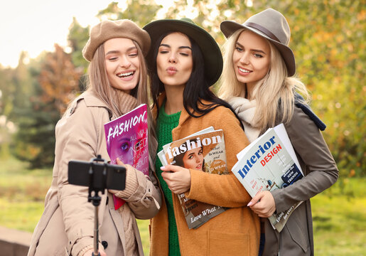 Beautiful young women taking selfie outdoors - Powered by Adobe