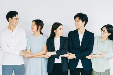 Asian young business people are holding hands to show solidarity