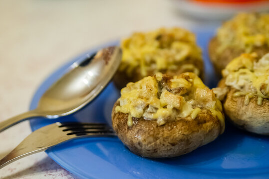 Grilled Mushrooms Stuffed With Cheese On Blue Plate