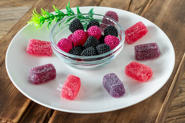 Chewing marmalade jelly candies with berry flavor on wooden table