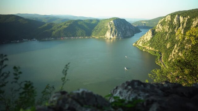 Timelapse of Cazanele Dunarii in the summer at sunset, we can see boats in the distance