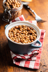 Mix of legume beans and chickpeas with sauce in pot.