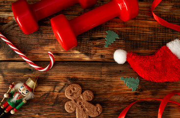 Red dumbbells, candy cane, Santa Claus hat, gingerbread man cookie, ribbon, tree ornaments and...
