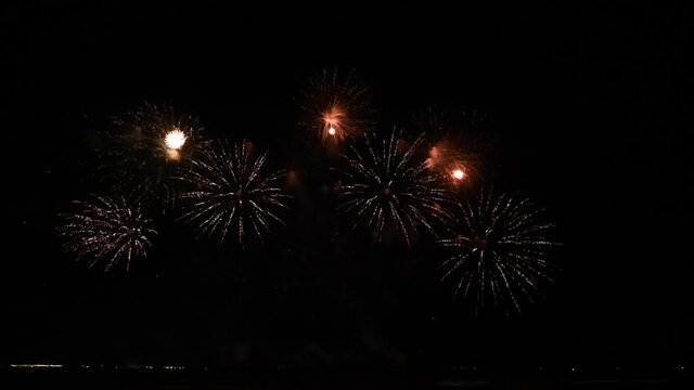 Elegant fireworks and fireworks display blurred on a black background