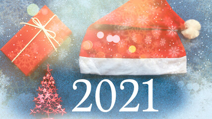 New Year concept. Santa Claus hat, gift, toy tree on a blue glitter background with the inscription.