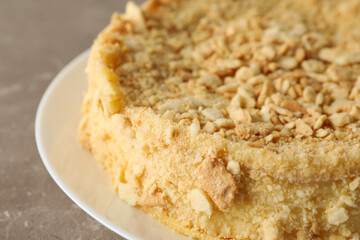 Plate with delicious Napoleon cake on gray table