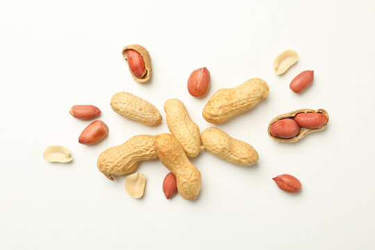 Tasty peanuts on white background, top view