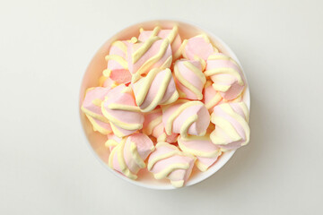 Bowl with marshmallow on white background, top view