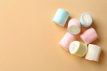 Sweet marshmallow on beige background, space for text