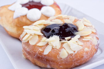 Donuts stuffed with fresh cream and jam closeup