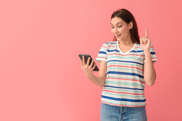 Young woman with e-reader on color background