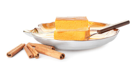 Plate with pieces of tasty pumpkin pie on white background