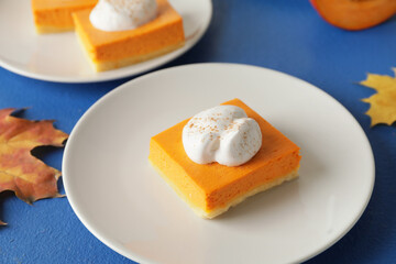 Plate with piece of tasty pumpkin pie on table