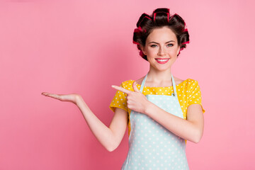 Portrait of her she nice pretty confident cheerful housewife holding on palm copy empty space advice isolated over pink pastel color background