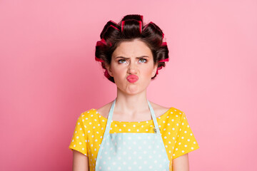 Close-up portrait of her she nice brown-haired housewife wearing curlers bad mood grimacing dislike pout lips isolated on pink pastel color background