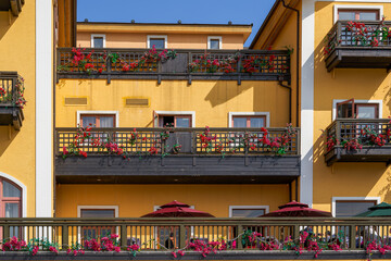 Partial close-up of balcony window of colorful building in European town