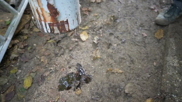 Smashing paint bucket with mattock