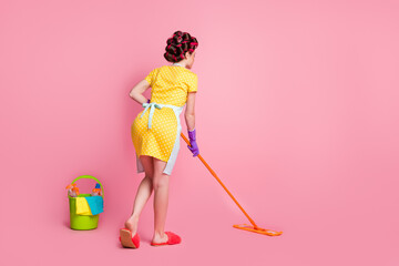Full size back rear spine view photo of girl wash mop floor wear yellow skirt latex gloves isolated...