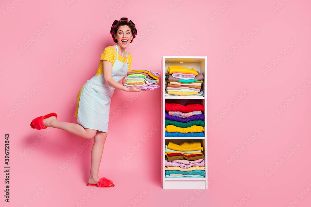 Wall mural full length body size view of glamorous glad cheerful maid organizing pile stack things belongings i