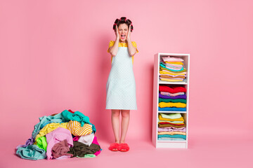Full size photo frustrated woman scream many huge heap clothes wear dotted dress isolated pink color background