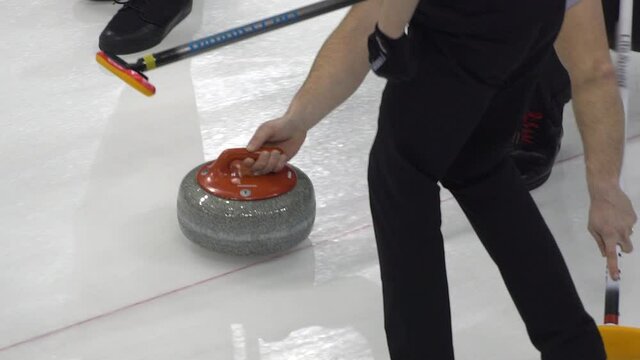 Curling. Winter Olympic sport. Curling stone. Winter sport in which players slide stones on a sheet of ice to special target.