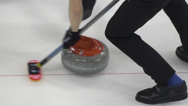 Curling. Winter Olympic sport. Curling stone. Winter sport in which players slide stones on a sheet of ice to special target.