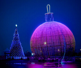 Huge Christmas ball and Christmas tree with Christmas lights. Good New Year spirit. Moscow. Decoration of city streets for the holiday.