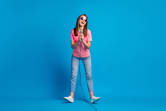 Full length body size photo of careless woman wearing sunglass singing microphone festival isolated on vivid blue color background