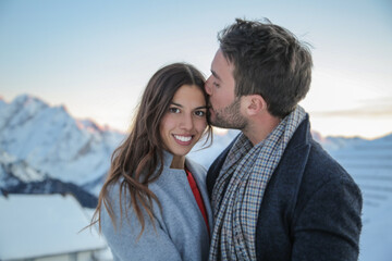 Man kissing girlfriend on forehead