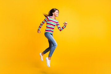 Fototapeta na wymiar Full length body size side profile photo of running fast happy schoolgirl smiling isolated on vivid yellow color background