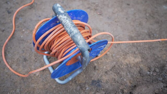Close up of cable stretched out of cable reel extension drum