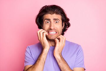 Photo of young upset handsome man hands touch chin afraid scared shocked panic isolated over pink color background