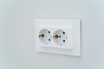 Newly instulled sockets in room with white wall. Repairing and reconstruction concept.