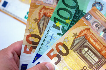 Euro currency close up in the hands of a rich man