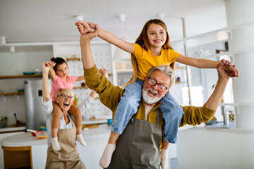 Grandchildren having fun, playing with grandparents at home