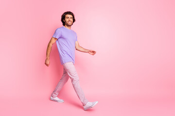 Fototapeta na wymiar Full body photo of walking person smile relaxed wear magenta clothing isolated on pink color background