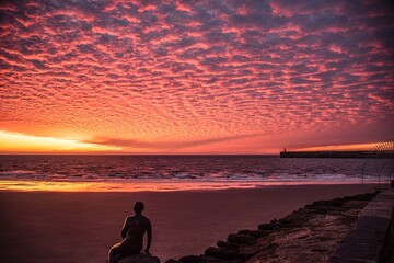 Sunrise at Sunny Sands in Folkestone. Altocumulus clouds reflect the light onto the beach.