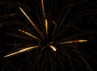 fireworks with yellow sparks on black background