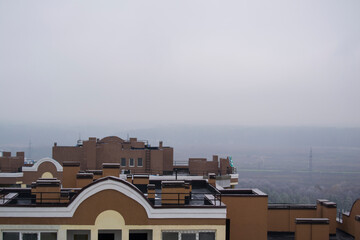 roofs of new houses with fog in the background