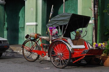Fototapeta na wymiar Rickshaw parked empty along the side of the road in George Town, Penang, Malaysia