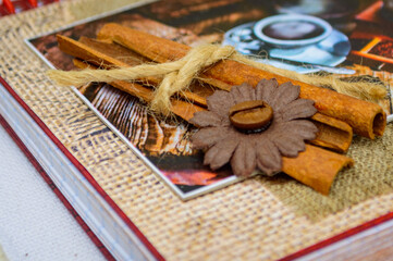 Heap of coffee beans, cinnamon stick