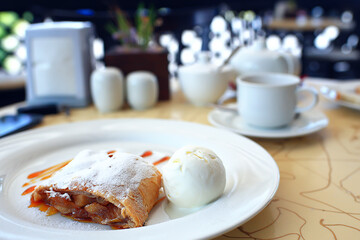 Austrian strudel with ice cream in a cafe, dessert in a restaurant background