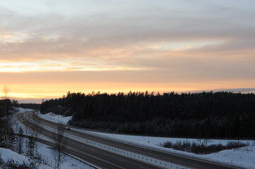 Winter driving on a snowy highway road during dusk and sunset in Sweden, Europe, Scandinavia