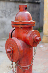 Fototapeta na wymiar Red fire hydrant water pipe near the road